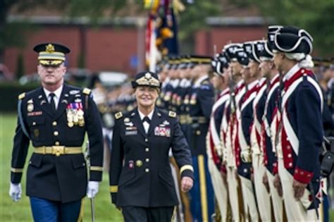 A commander inspecting troops, with a parade or other formal ceremony in the background