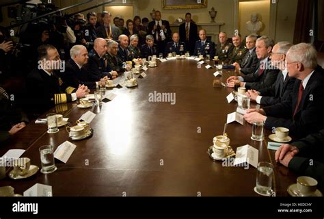 A commander meeting with leaders, with a formal ceremony or meeting in the background