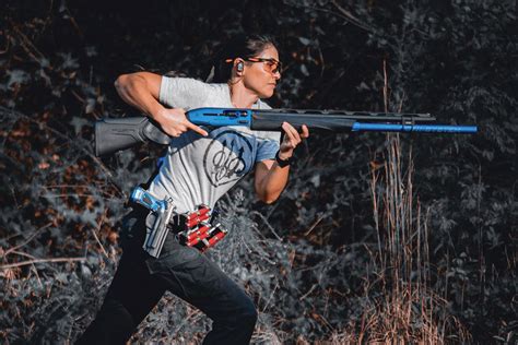 A competitive shooter in action with a custom-built race gun