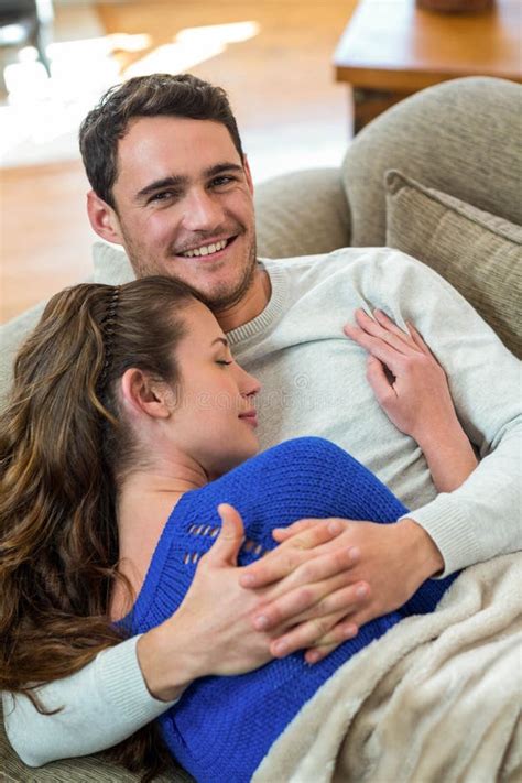 Couple cuddling on the couch