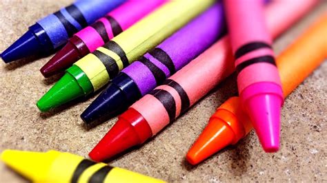 A child holding a blue crayon