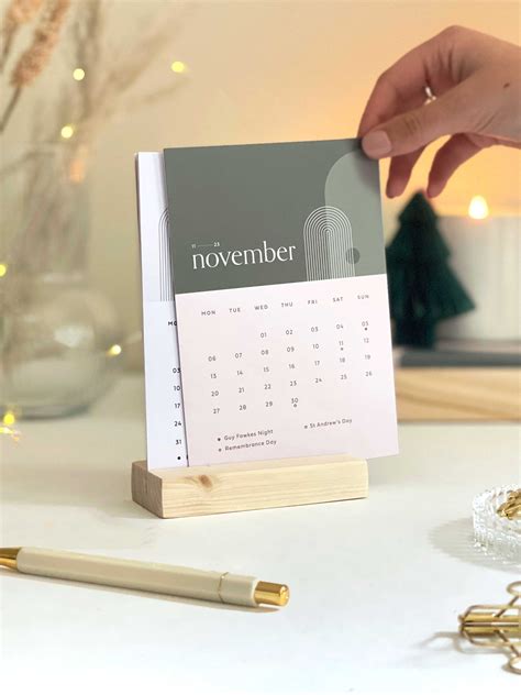 Person using a desk calendar with a cup of coffee