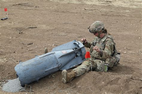 EOD techs examining an explosive device