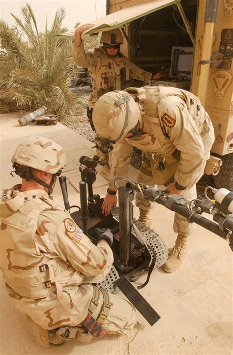 EOD technicians disarming an explosive device