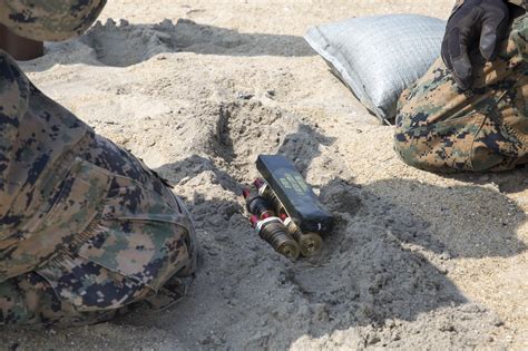 EOD technicians documenting an explosive device