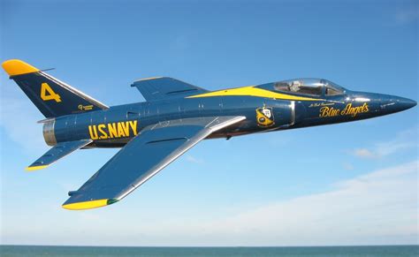 F-11 Tiger in Blue Angels livery performing a stunt