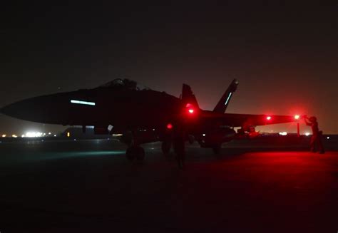 F/A-18 Hornet flying at night with afterburners