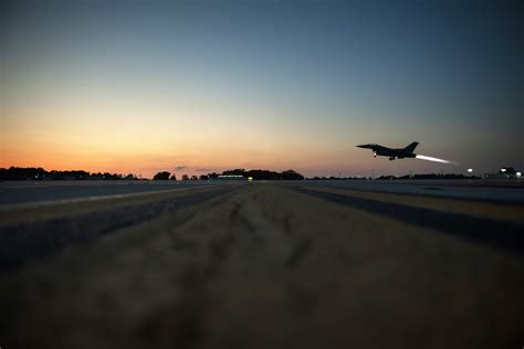 Falconer training a falcon at night