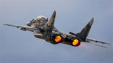 A fighter jet with wings and afterburners