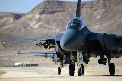 A fighter plane taking off from a grassy runway