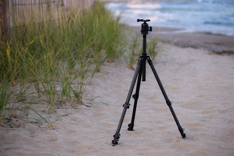 Photographer setting up tripod to capture US flag at night