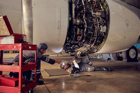 Flight engineer checking engine