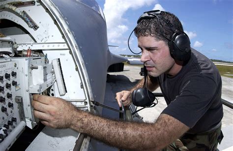 Flight engineer working on avionics