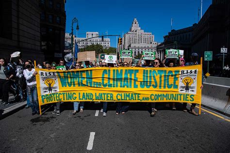 People holding signs that read 'Climate Action Now'