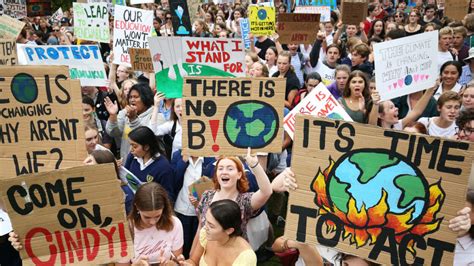 People holding signs that read 'Save the Planet'