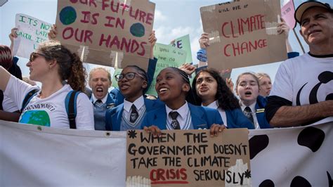 People holding signs that read 'Justice Now'