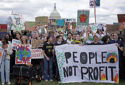 People holding signs that read 'Fair Pay Now'