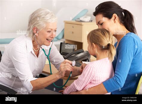 A GP examining a child