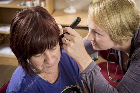 General Practitioner Examining Patient