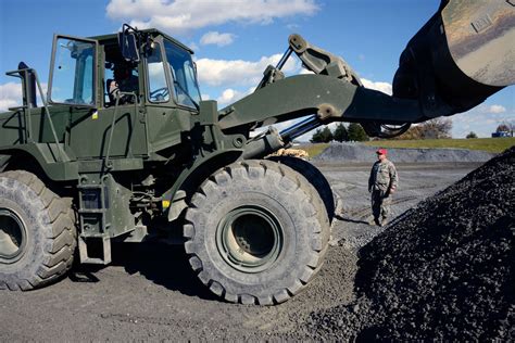 Heavy equipment operator maintaining equipment