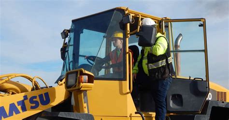 Heavy equipment operator working with a team