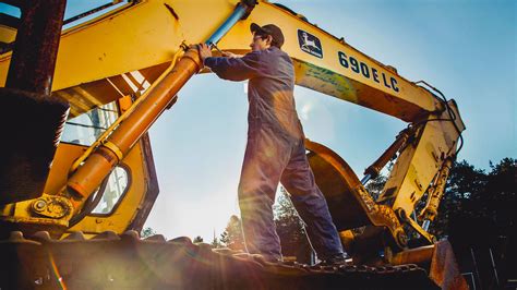 Heavy Machinery Operator Performing Maintenance