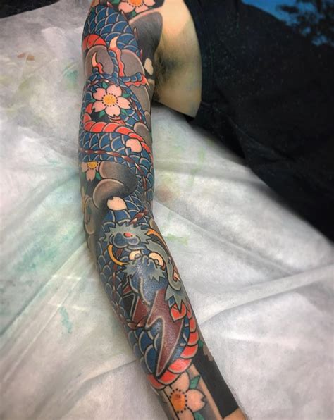 Japanese tattoo sleeve designs with cherry blossoms and dragons