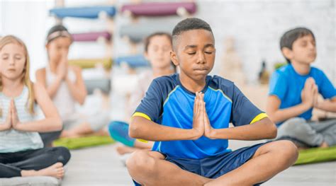 Kids practicing yoga in a boot camp