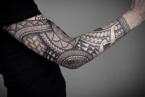 Maori tattoo sleeve designs with tribal patterns and spirals