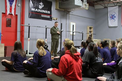 Marine Corps Delayed Entry Program recruits training on the obstacle course.