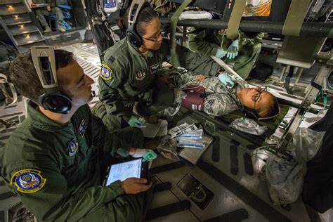 Medical evacuation teams transport wounded soldiers to medical facilities