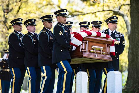 A military funeral with taps being played