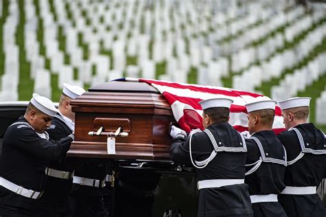 A military funeral with a bugler playing Taps