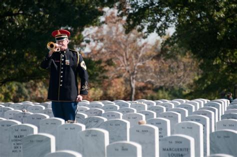 A lone bugler plays Taps at a military funeral