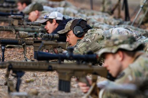 Military personnel using marksmanship training devices