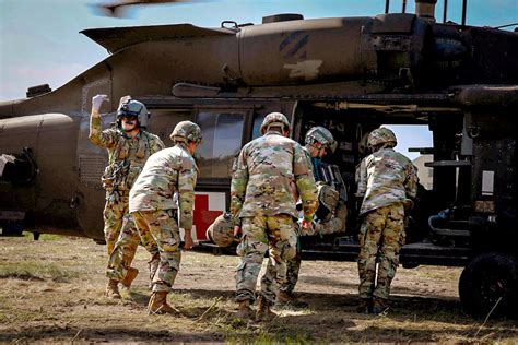 Military personnel using defibrillators