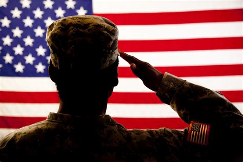 A military member showing respect during taps