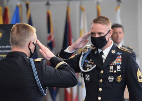 Military personnel saluting during a ceremony