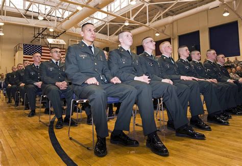 Military school faculty members interacting with students