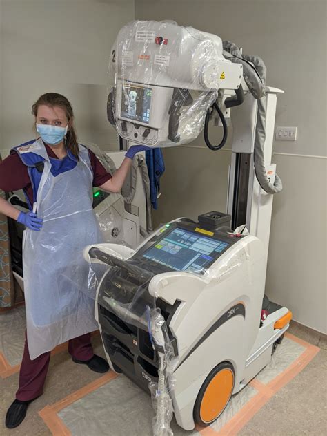 Mobile X-ray nurse assisting patient