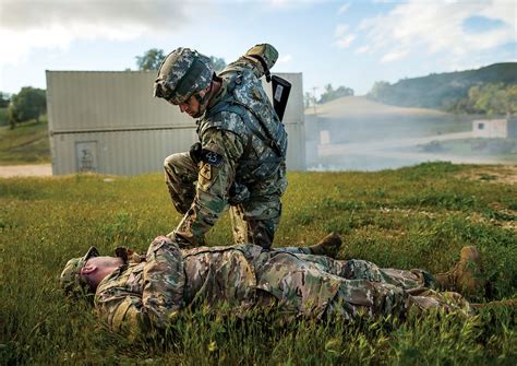 Combat medic providing medical aid in a war zone