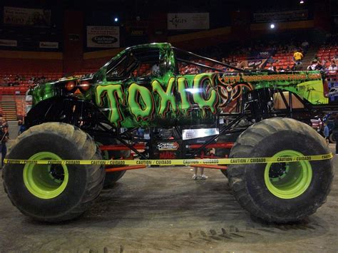 A packed stadium watching a monster truck race