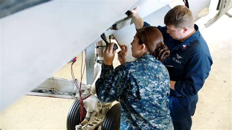 Naval Officer Maintaining Aircraft