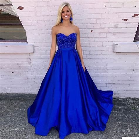 Navy prom dress accessorized with statement jewelry