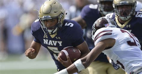 Navy Quarterback Leading Team onto Field