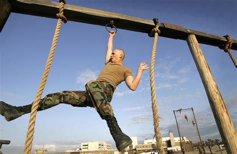 Navy SEALs navigating an obstacle course