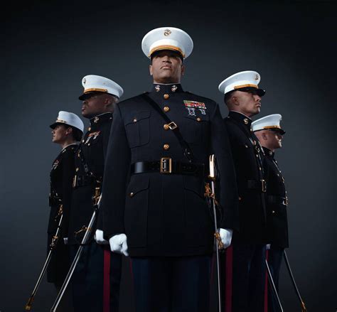 A group of officers in uniform, standing in front of a flag