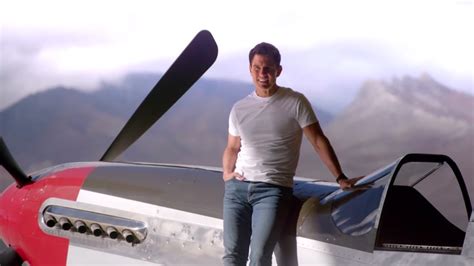 Tom Cruise standing next to his P-51 Mustang