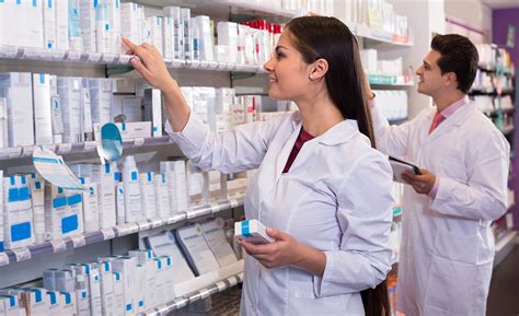 Pharmacy technician using automated dispensing system