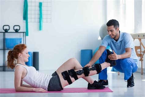 A physical therapist working with an Airman